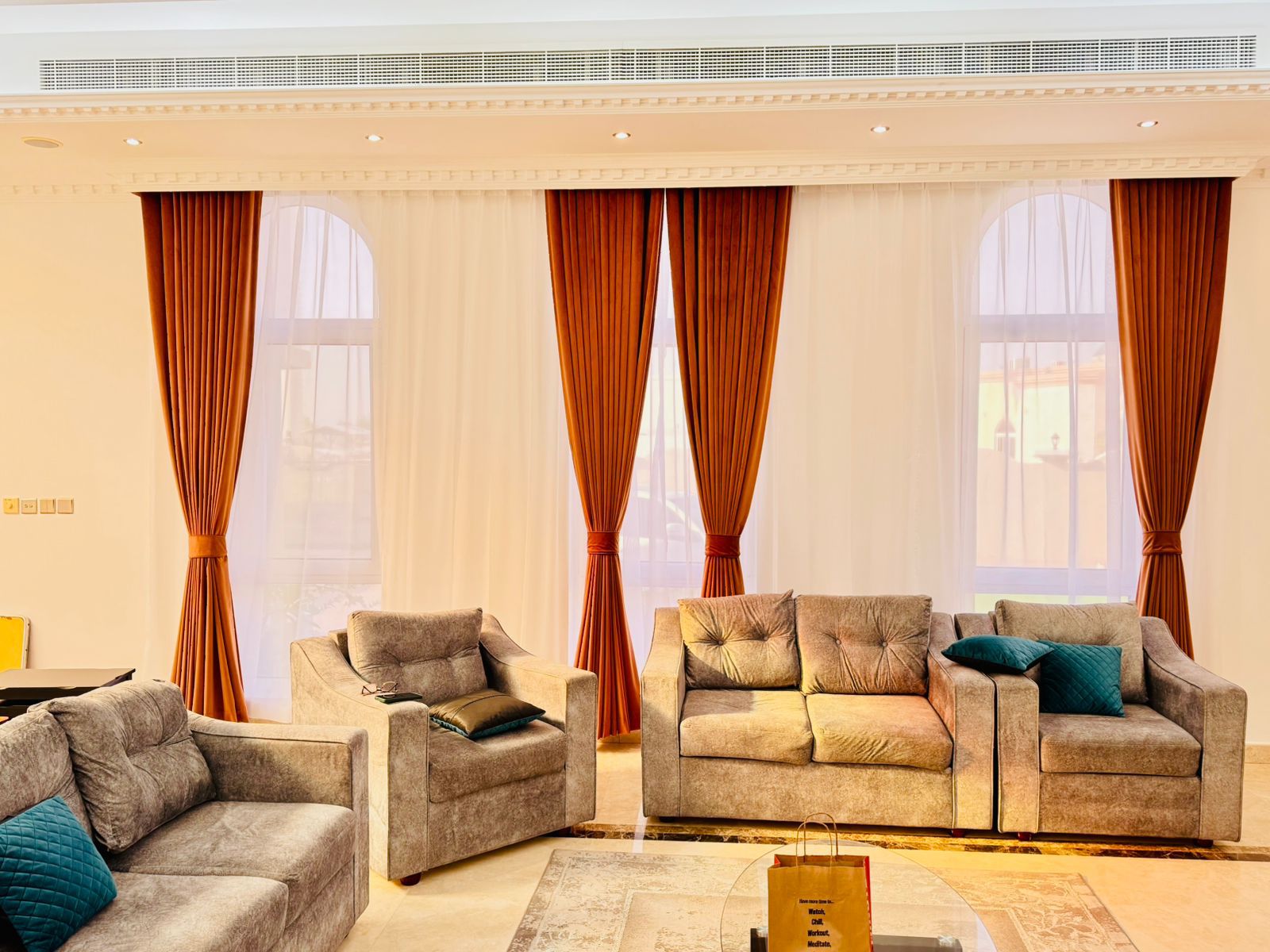 Traditional luxury swaged drapery in ivory and gold brocade with ornate tassel trimming