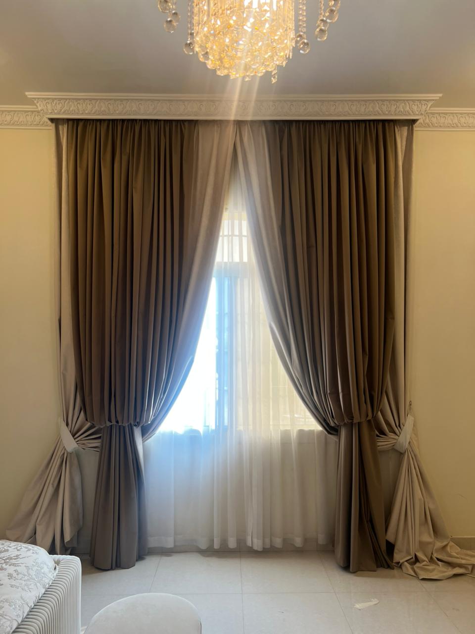 Elaborate classic drapery setup showing customized valances with deep fluid velvet swags