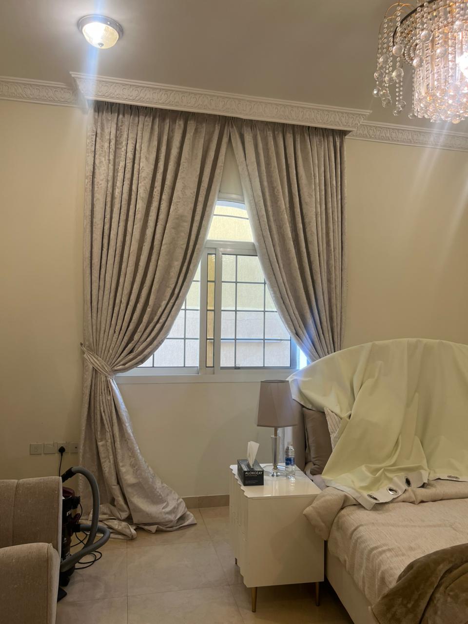 Elegant floor-length classic tailored linen curtains framing a bedroom window